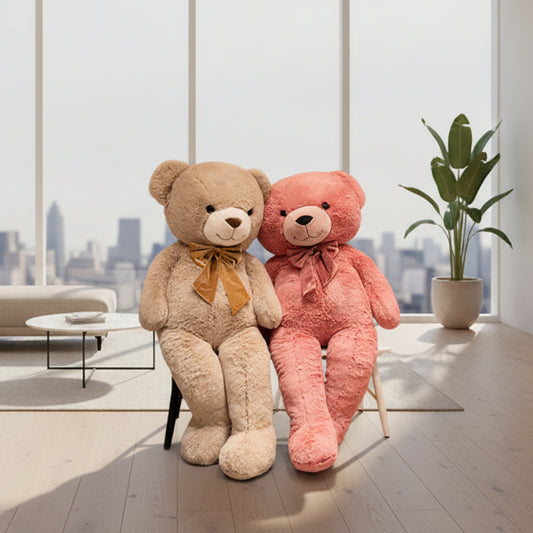 Two teddy bear plush toys in beige and pink colours sitting together in a modern living room with large windows
