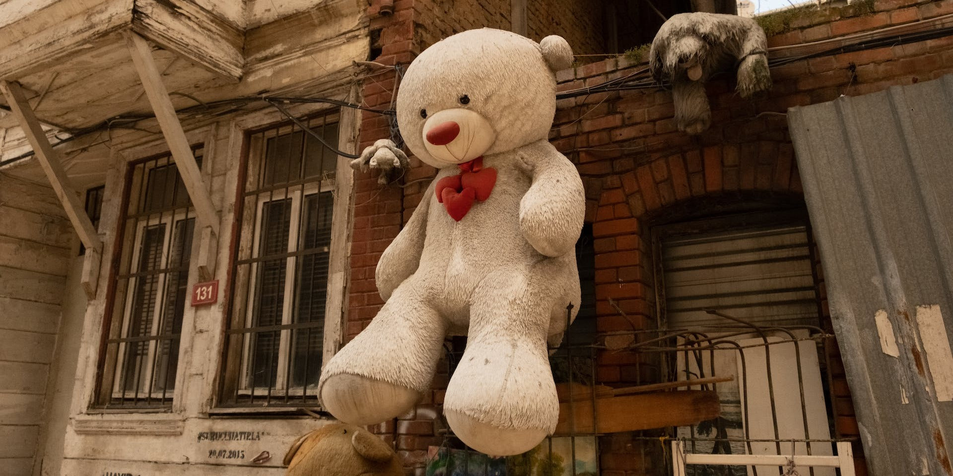 Giant teddy bear plush toy displayed outdoors
