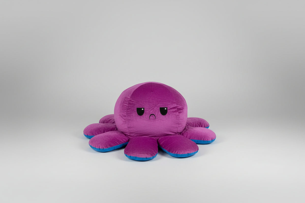 Small reversible octopus plush toy with angry purple face and blue trim displayed on a white background.