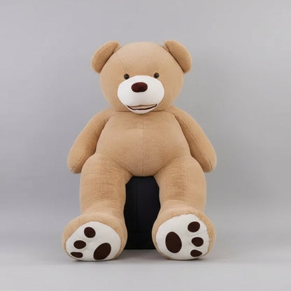 Large brown teddy bear in a room with decorative items