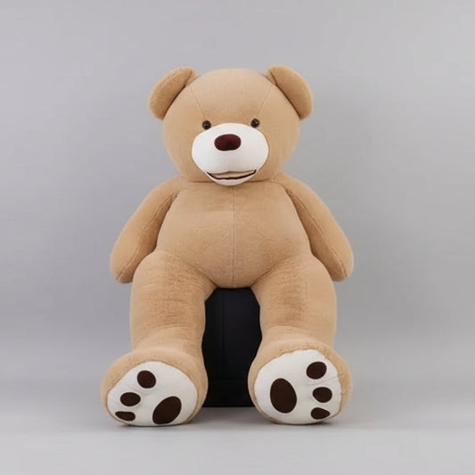 Large brown teddy bear in a room with decorative items