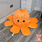 130cm orange and yellow reversible octopus plush toy with sad face displayed on a wooden floor.