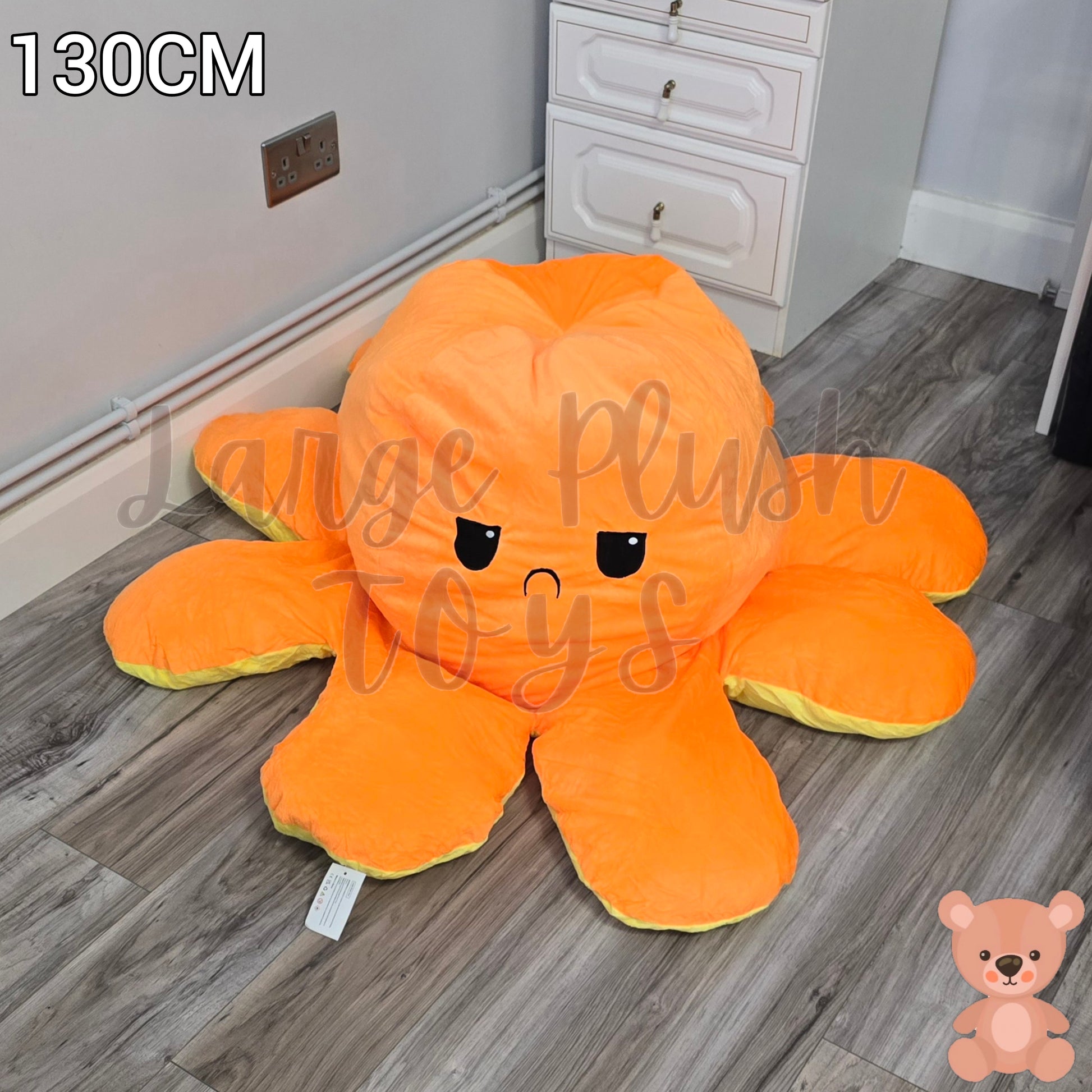 130cm orange and yellow reversible octopus plush toy with sad face displayed on a wooden floor.