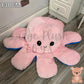130cm pink and blue reversible octopus plush toy with happy face displayed on a wooden floor.