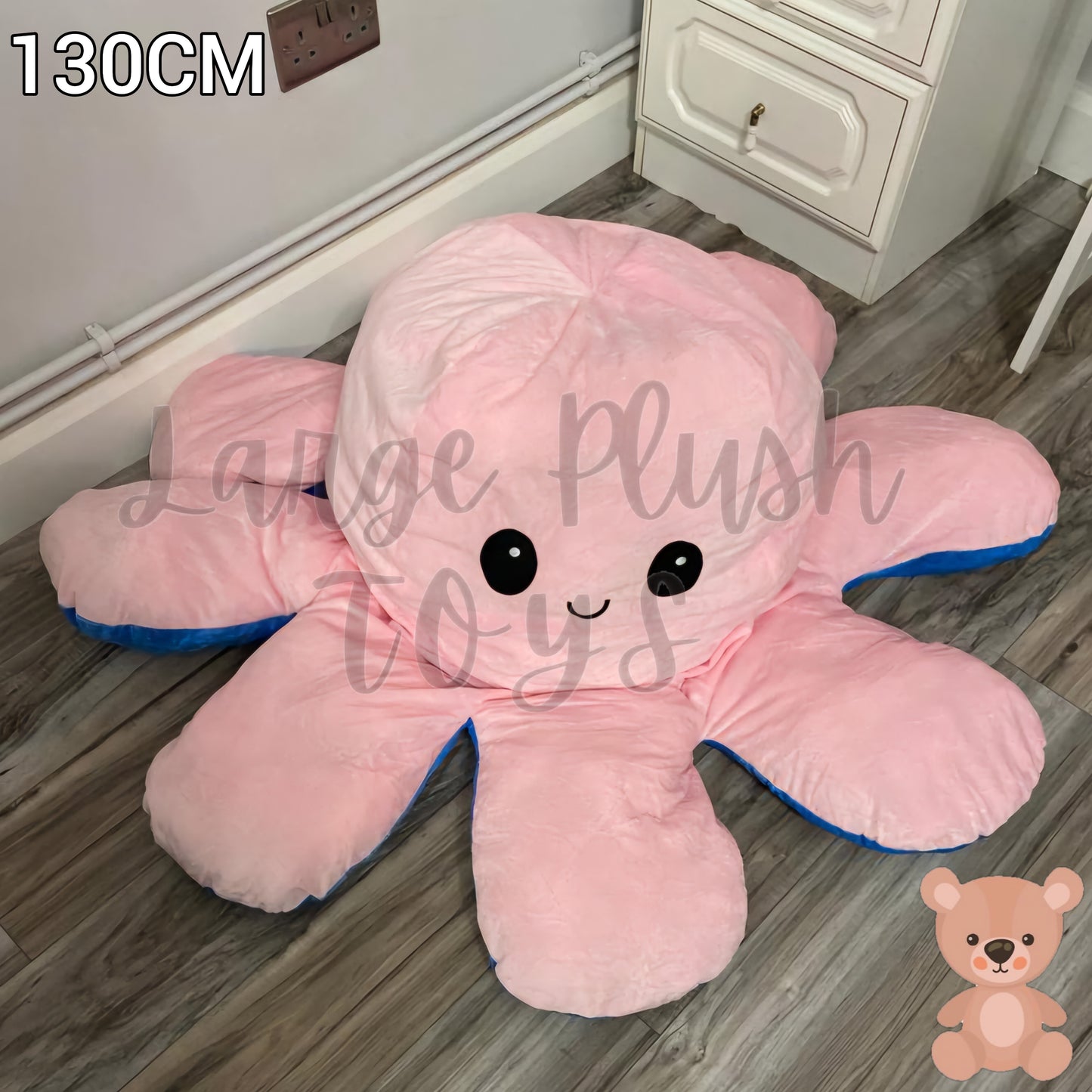 130cm pink and blue reversible octopus plush toy with happy face displayed on a wooden floor.