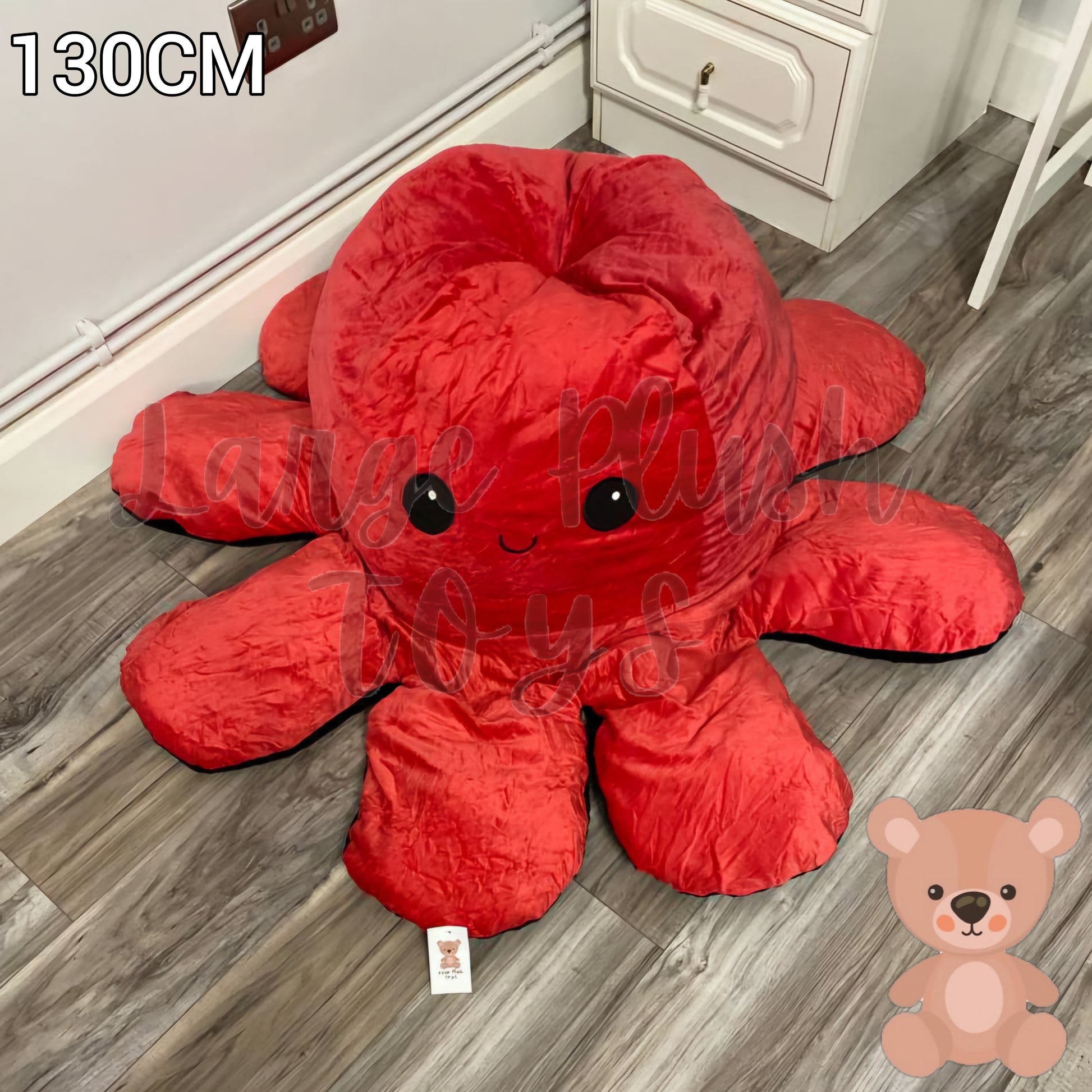 130cm reversible octopus plush toy with happy red face displayed on a wooden floor in a home setting.