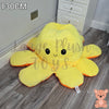 130cm yellow and orange reversible octopus plush toy with happy face displayed on a wooden floor.
