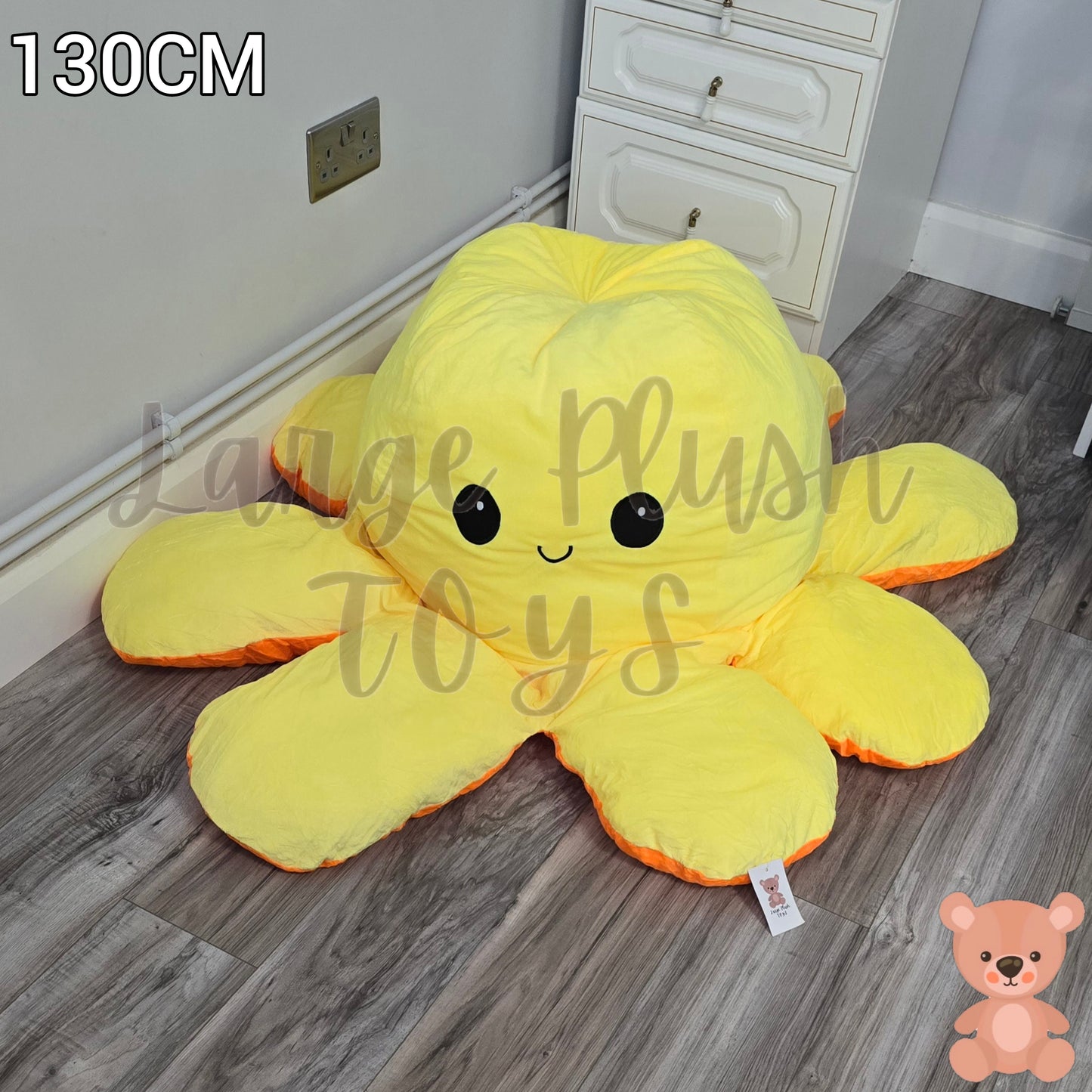 130cm yellow and orange reversible octopus plush toy with happy face displayed on a wooden floor.