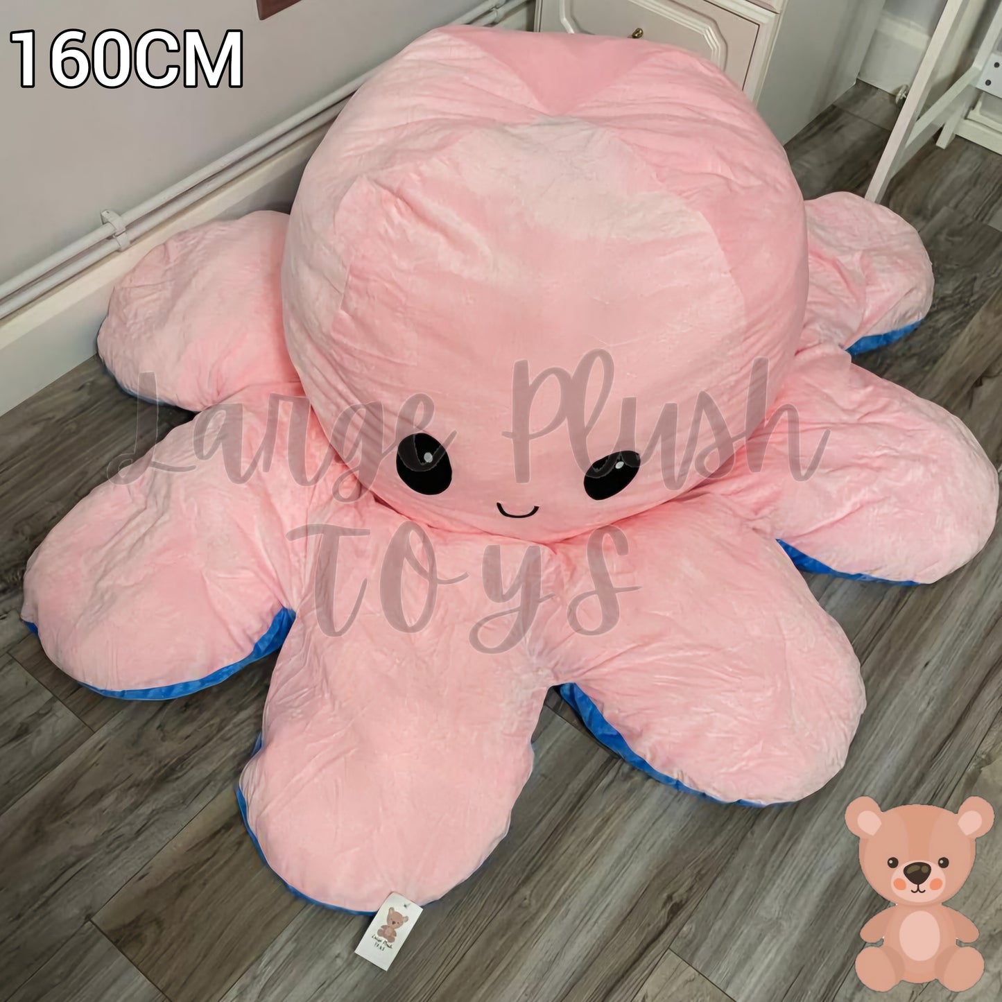 160cm pink and blue reversible octopus plush toy with happy face displayed on a wooden floor.