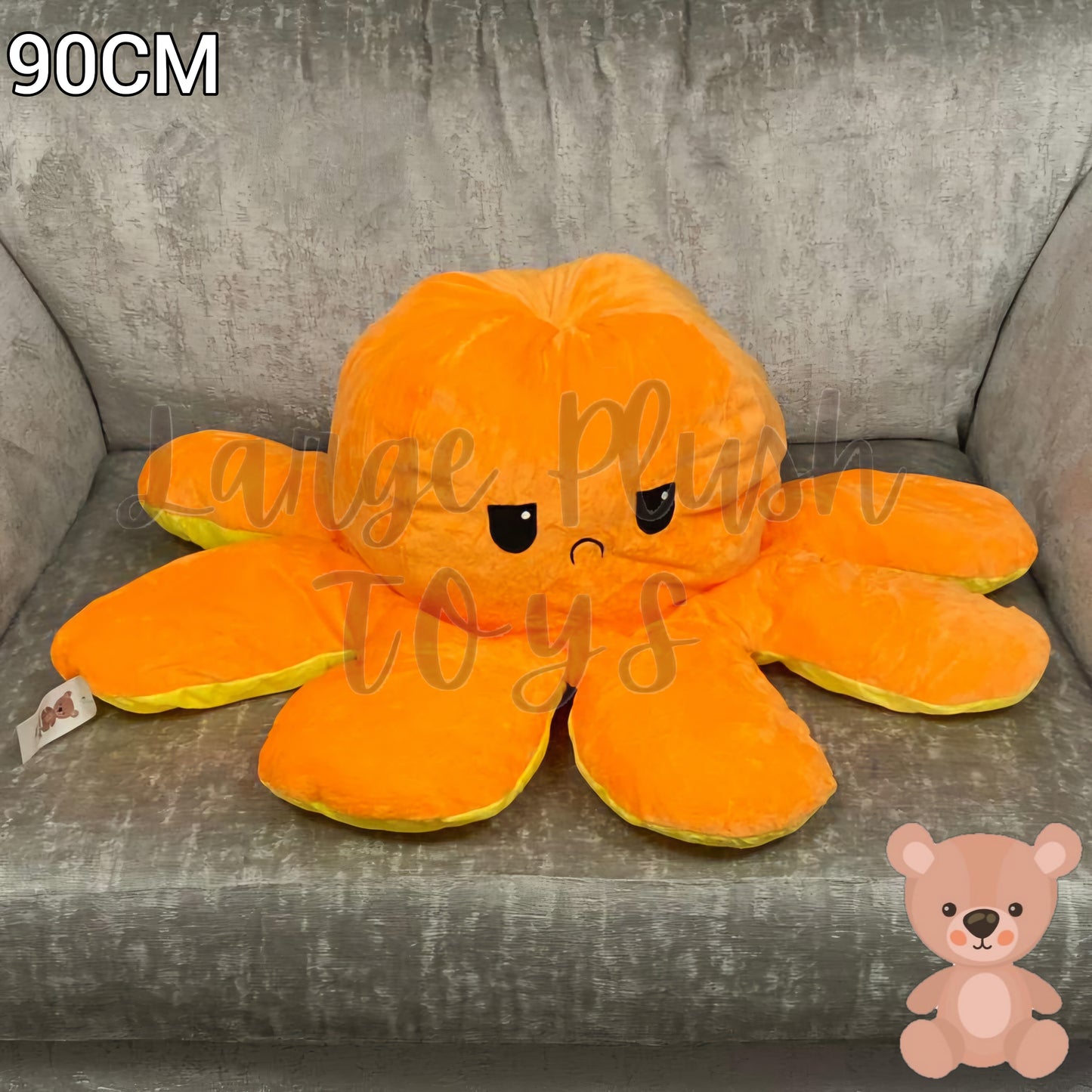 90cm orange and yellow reversible octopus plush toy with sad face displayed on an armchair.