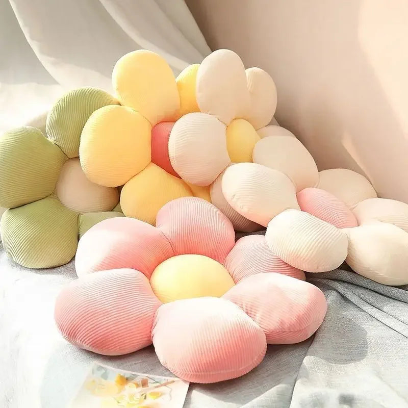 Flower-shaped pillow with pastel colors on a soft surface