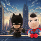 Batman and Superman plush toys displayed together with a city skyline background