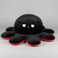 Black and red reversible octopus plush toy with angry face displayed on a white background.