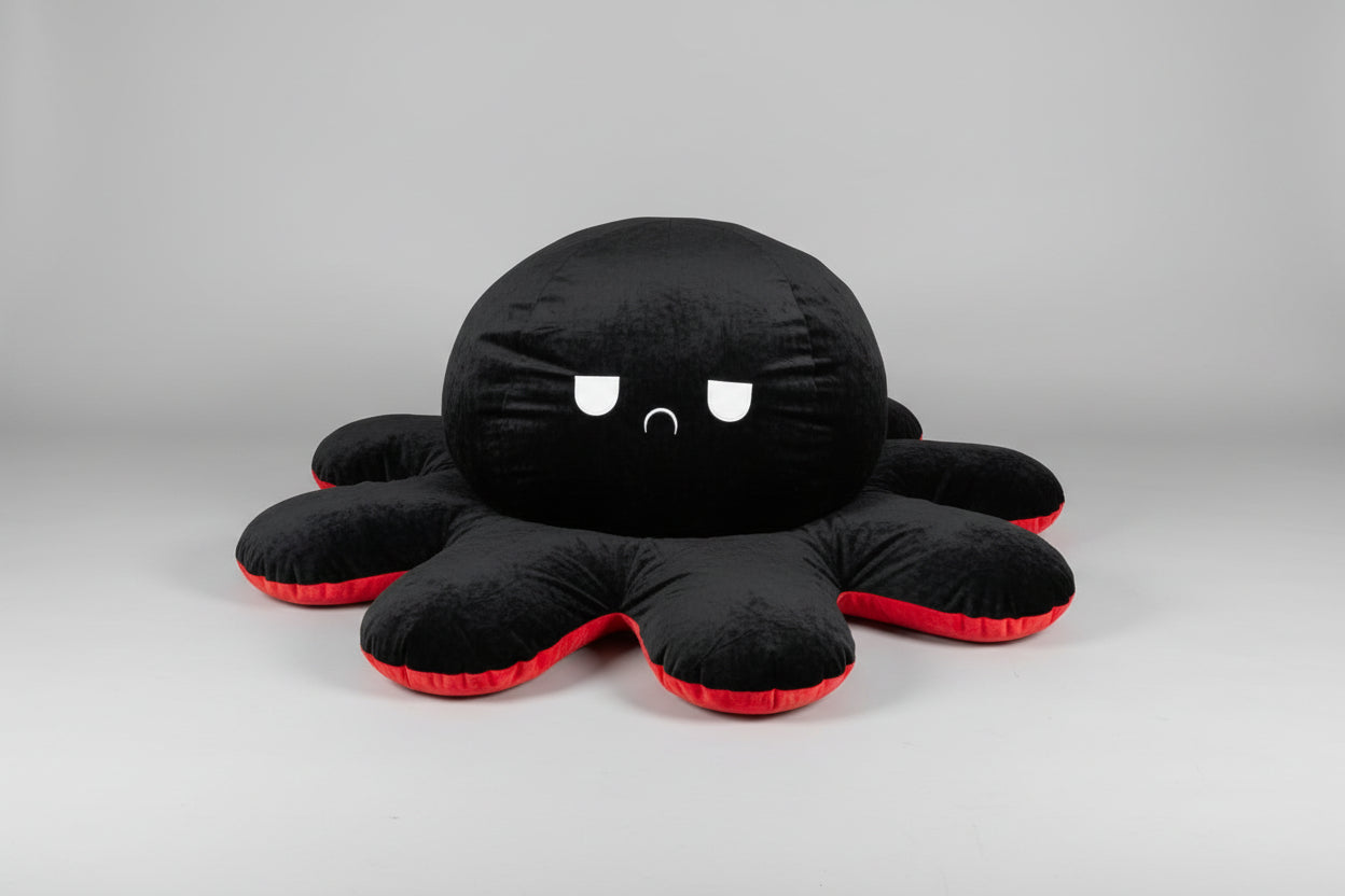 Black and red reversible octopus plush toy with angry face displayed on a white background.