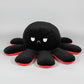 Black and red reversible octopus plush toy with frowning face displayed on a white background.