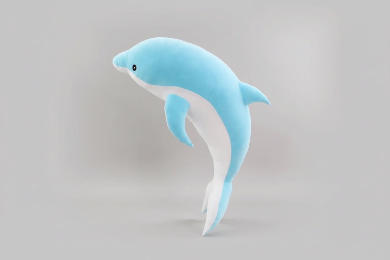 Blue and white dolphin plush toy standing upright on a light grey background.