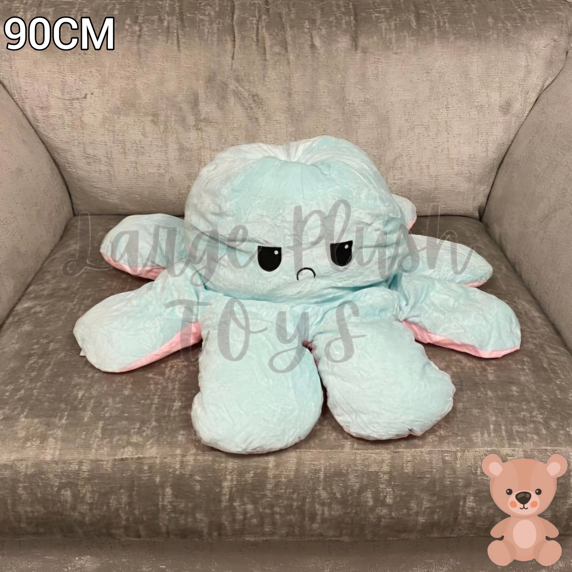 90cm blue and pink reversible octopus plush toy with angry face displayed on a grey armchair.