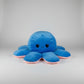 Blue and pink reversible octopus plush toy with angry face on a white background.
