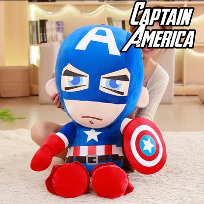 Large Captain America Marvel Avengers plush toy with shield sitting on a sofa in a living room.