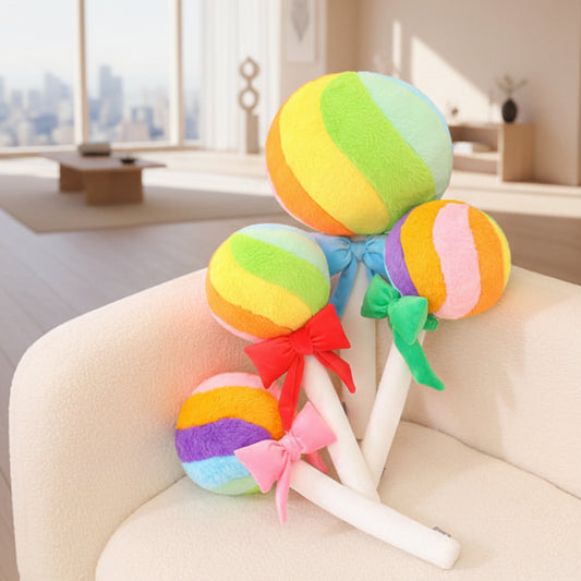Colourful lollipop plush toys with decorative bows displayed on an armchair in a modern living room.