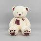 Cream teddy bear plush toy with love heart details, soft scarf and embroidered paw design.