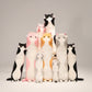 Collection of cute standing cat plush toys in assorted colours including black, white, pink, grey and orange displayed together.