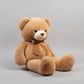 Large brown teddy bear plush toy with a brown bow sitting on a light grey background