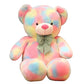 Large rainbow pastel teddy bear plush toy with a decorative bow sitting on a white background