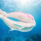 Pink and blue dolphin plush toys swimming underwater with ocean bubbles and coral reef background.