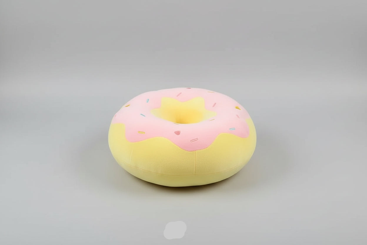 Pink and yellow donut plush pillow with colourful sprinkle details and soft stuffed cushion design.