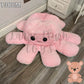 130cm pink and blue reversible octopus plush toy with happy face displayed on a wooden floor.