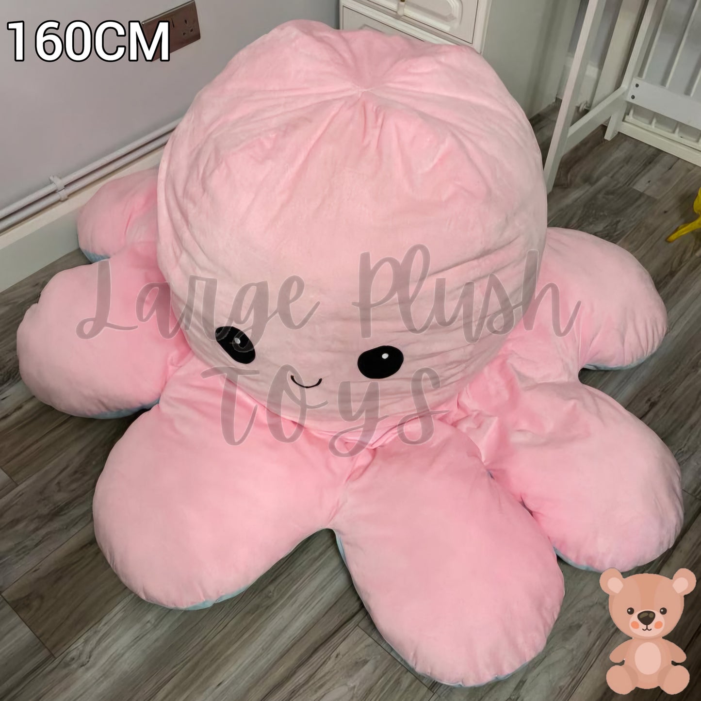 160cm pink and blue reversible octopus plush toy with happy face displayed on a wooden floor.