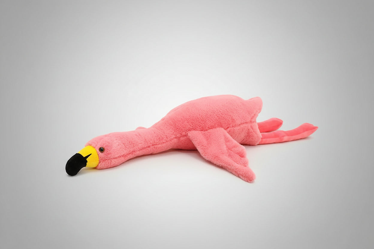Pink flamingo plush toy lying flat on a white background