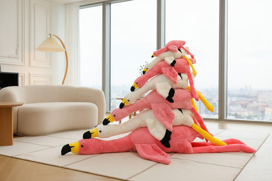 Stack of pink flamingo plush toys displayed in a modern living room setting