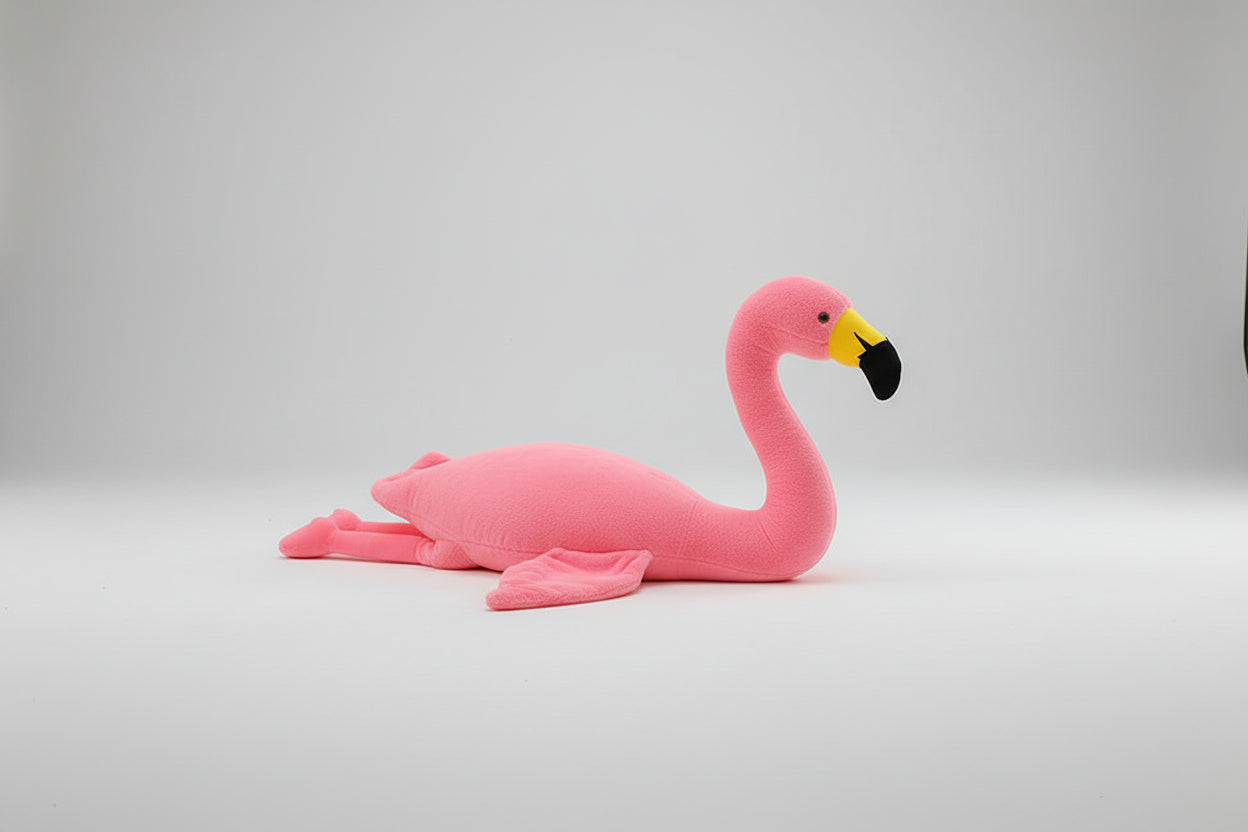Pink flamingo plush toy with upright neck displayed on a white background