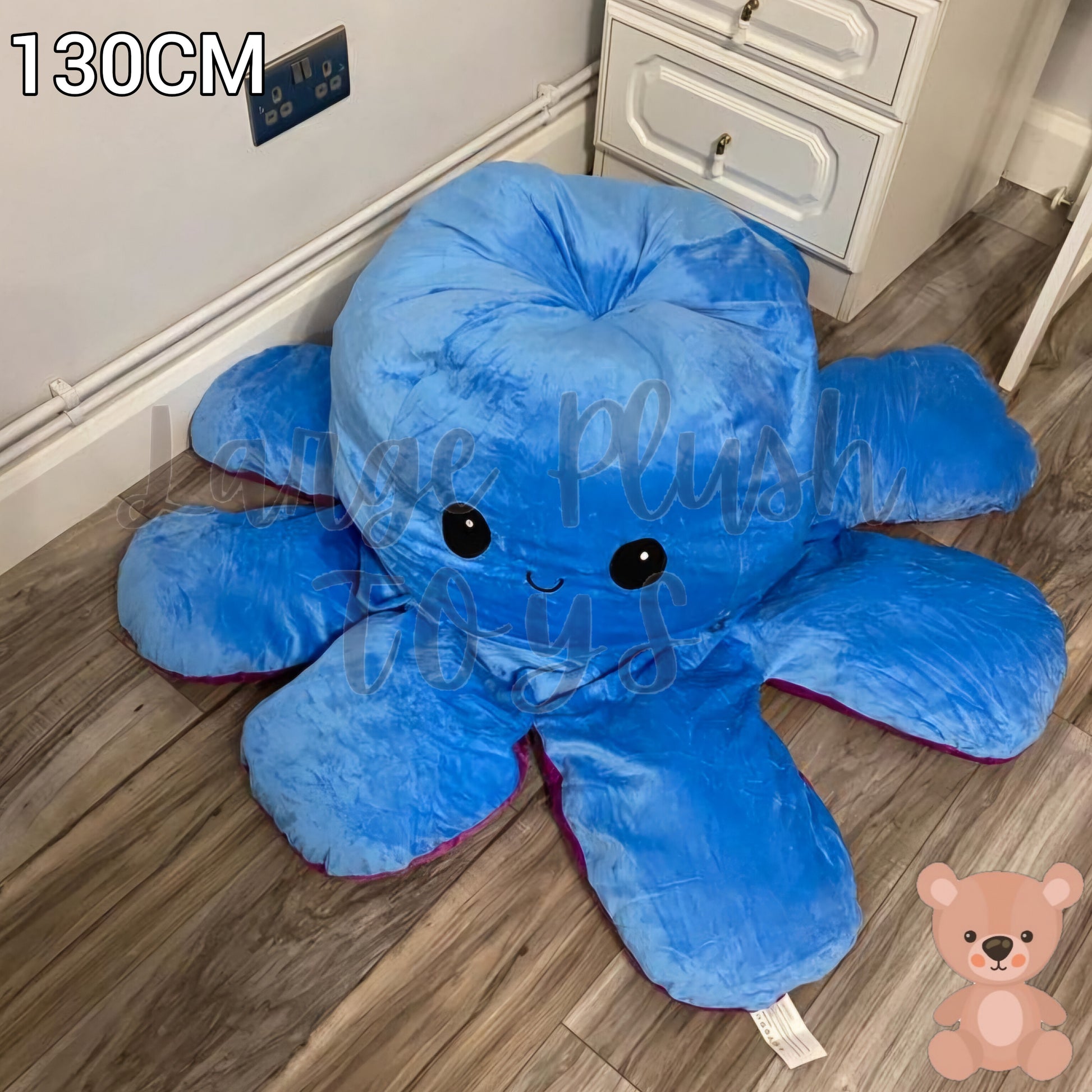 130cm reversible blue and purple octopus plush toy with happy expression, giant soft stuffed cushion displayed on a wooden floor.