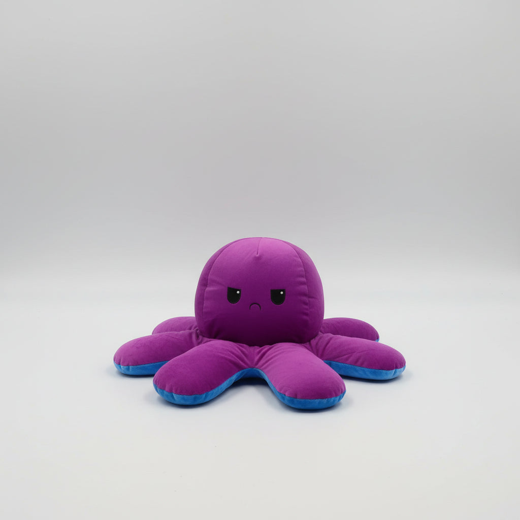 Small reversible purple and blue octopus plush toy with angry expression, soft stuffed cushion displayed on a white background.