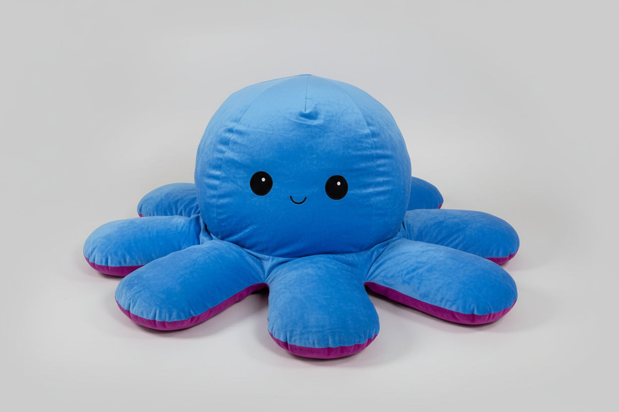 Large reversible blue and purple octopus plush toy with happy expression, soft stuffed cushion displayed on a white background.
