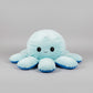 Pastel blue reversible octopus plush toy with a happy smiling face, soft stuffed cushion for kids, sensory play and bedroom decor.