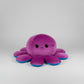 Small reversible octopus plush toy with angry purple face and blue trim displayed on a white background.