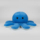 Dark blue reversible octopus plush toy with a sad expression, soft stuffed cushion for children, bedrooms and sensory comfort.