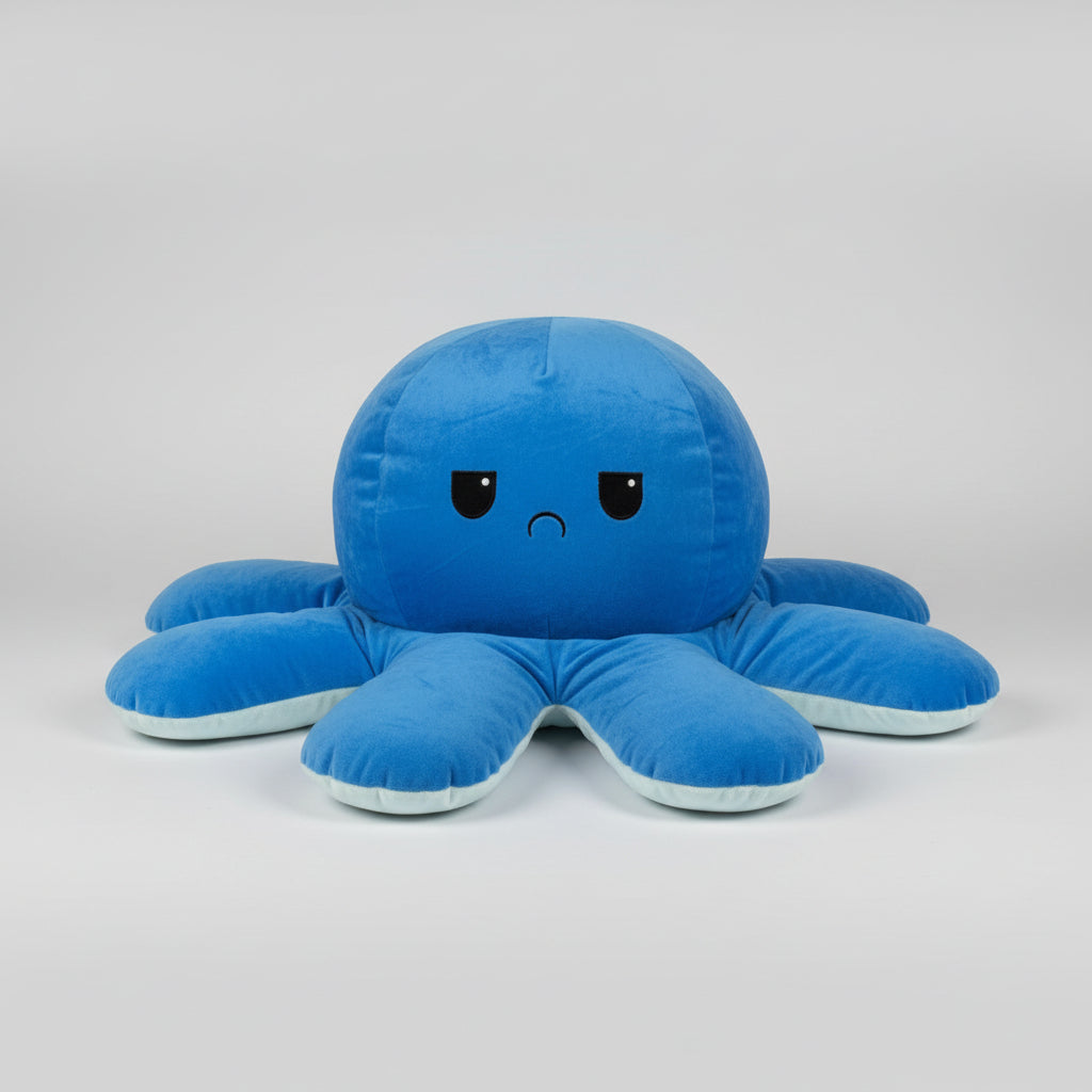 Dark blue reversible octopus plush toy with a sad expression, soft stuffed cushion for children, bedrooms and sensory comfort.
