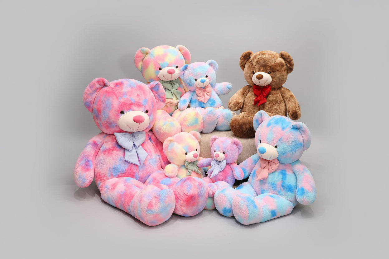 Teddy bear plush toy family collection featuring pastel pink blue rainbow and brown stuffed bears in multiple sizes