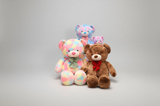 Soft teddy bear plush toy set featuring pastel rainbow bears and a brown teddy bear on a white background