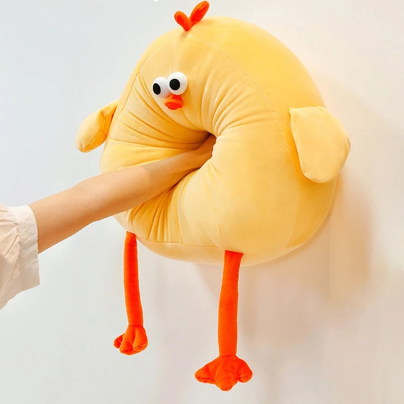 Yellow chicken plush neck pillow with soft cushion design, cartoon face and dangling legs for travel comfort.