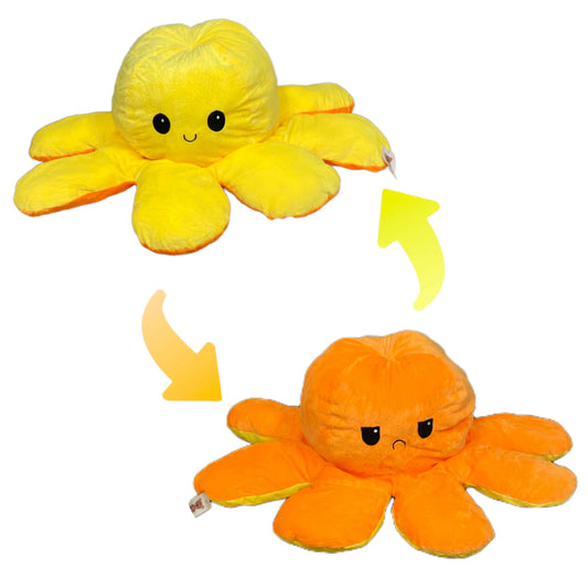 Yellow and orange reversible octopus plush toy with happy and sad mood expressions on a white background.